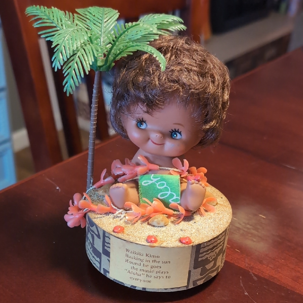 Vintage musical Hawaiian kewpie doll, rotating Aloha song, 1970s